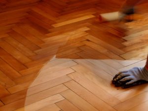 Hardwood parquet flooring undergoing restoration